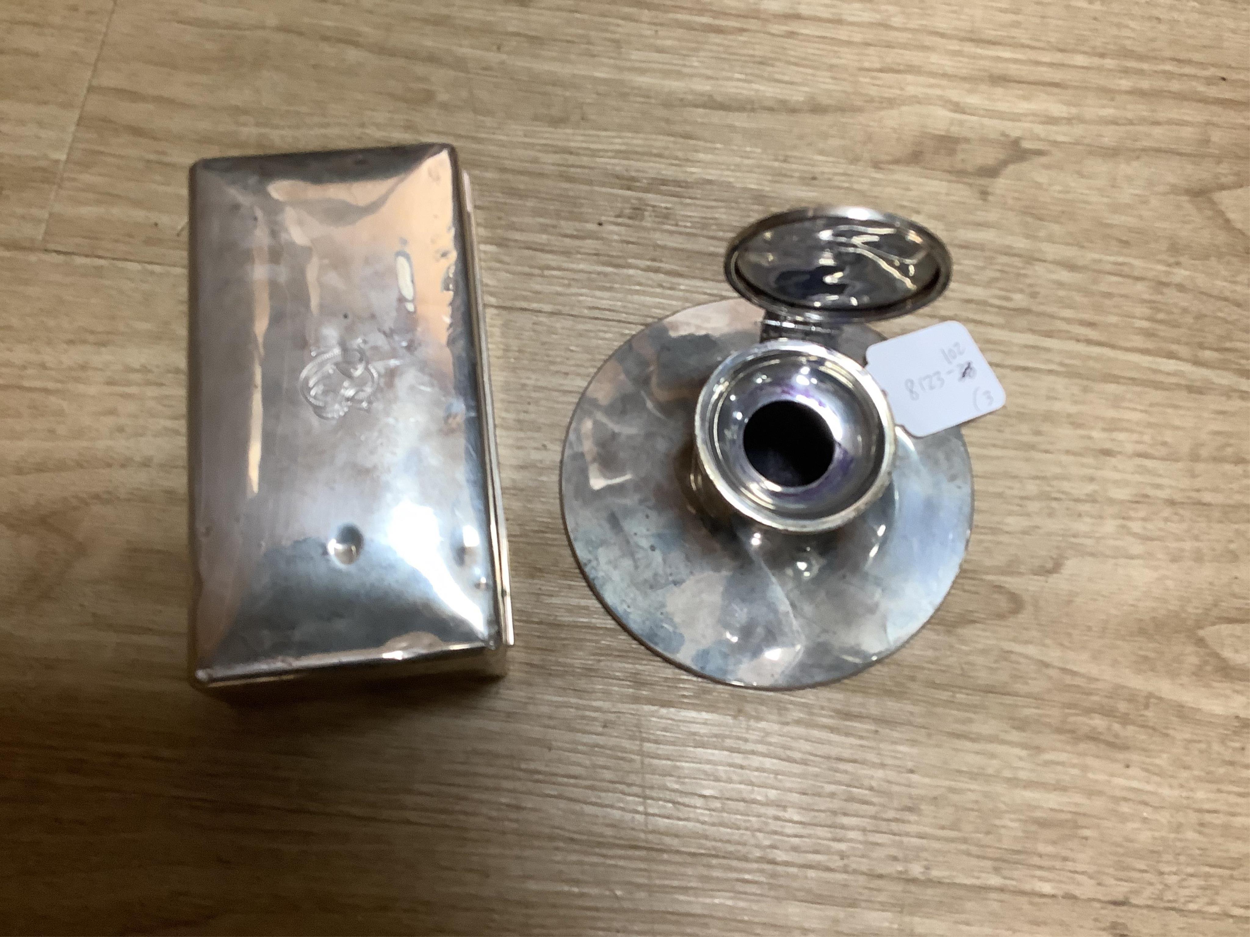 A silver mounted capstan inkwell, Birmingham, 1914, a silver mounted cigarette box and a cased pair of silver menu holders. Condition - poor to fair